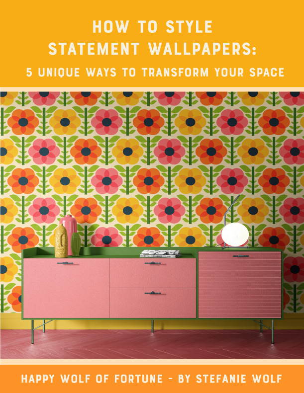 Preview of a PDF freebie. Title page of "How to style statement wallpapers: 5 unique ways to transform your space" by Happy Wolf of Fortune by Stefanie Wolf. The title page shows a room with a soft pink and grass green dresser. The wall is decorated with a bold retro wallpaper with geometric, yellow, pink and orange flowers with green foliage.