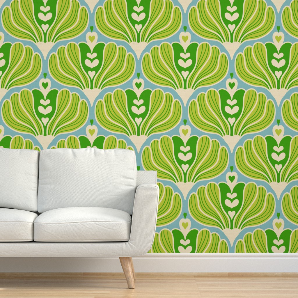 Mid-century modern living room showcasing removable wallpaper with a repeating blue background and green stylized floral pattern behind a white sofa with wooden legs on a light wood floor.