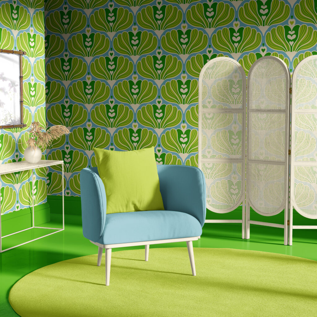 Scandinavian style wallpaper with bold green and yellow abstract floral pattern on light blue background, styled in a bright living room corner featuring a light blue armchair with a green cushion, green floor, round green rug, white console table with dried plants, and a white woven folding screen.