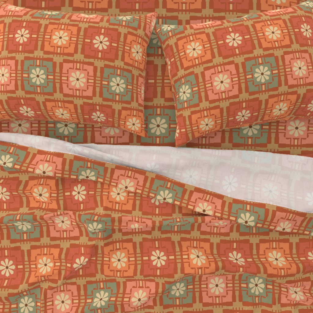 Duvet cover and pillows featuring a 1950s-inspired geometric floral square pattern in warm orange, muted pink, and sage green tones, displayed on a bed with white sheets. The design combines mid-century modern bold shapes and contemporary earthy colors for a cozy bedroom setting.