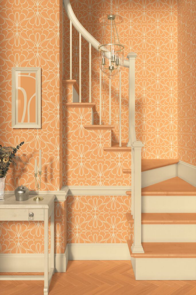 Wallpaper in warm apricot with abstract, fluent line pattern in a retro and mid-century modern style, applied on staircase walls with cream and beige wood trim and flooring. Includes minimal decor such as a small console table with candles and dried flowers, and a modern hanging light fixture.