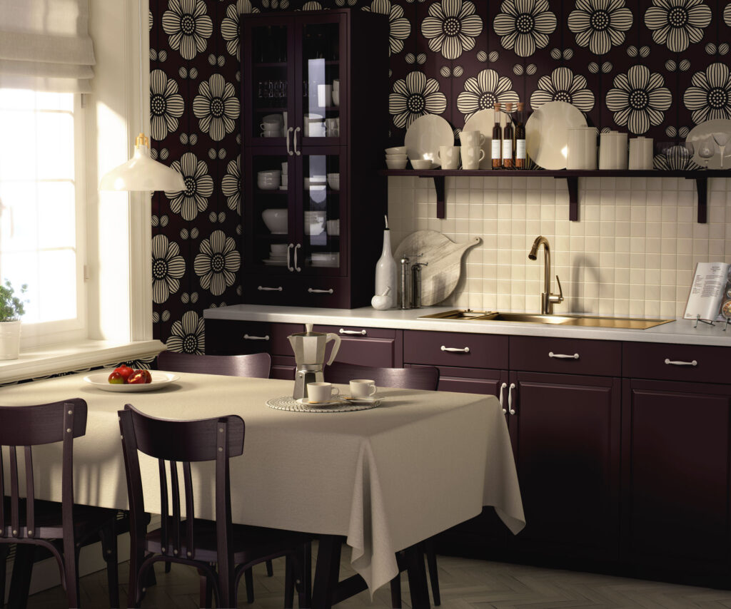 Modern farmhouse kitchen with deep plum cabinets and large-scale cream floral wallpaper on the walls, featuring a linen-textured plum background, white tile backsplash, brass faucet, wood dining table with beige tablecloth, and matching plum chairs in warm natural light.